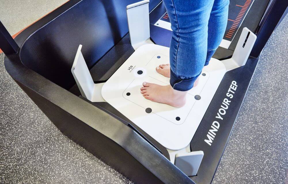 close up of women's feet standing on the MyFit machine